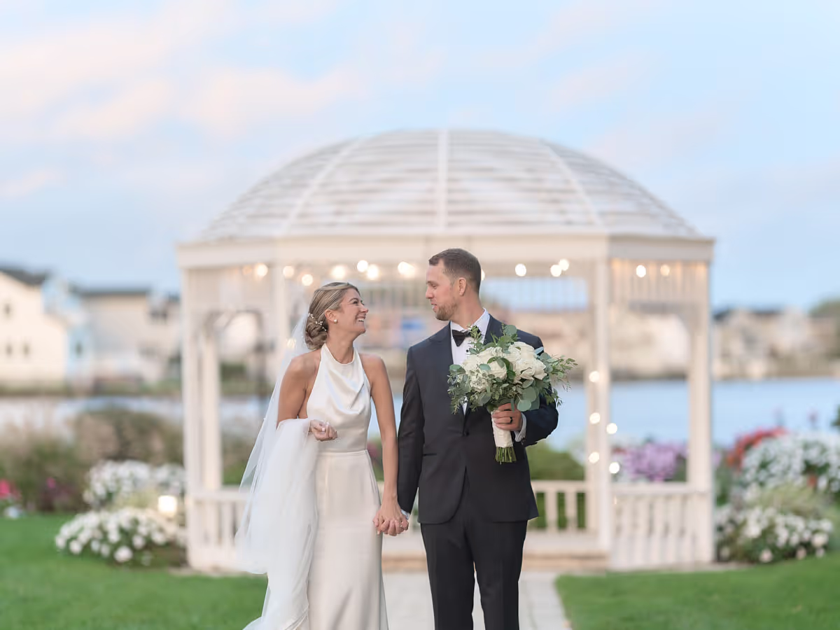 Vineyards on Long Island, Couple in front of a lit waterfront gazebo at dusk