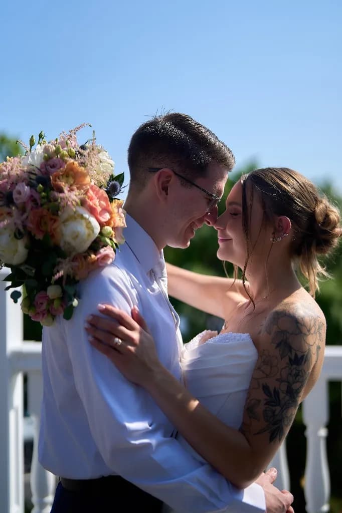 Ballrooms and Catering Halls on Long Island, Bride and groom kiss at the end of the aisle in front of the waterfront gazebo at the Riviera