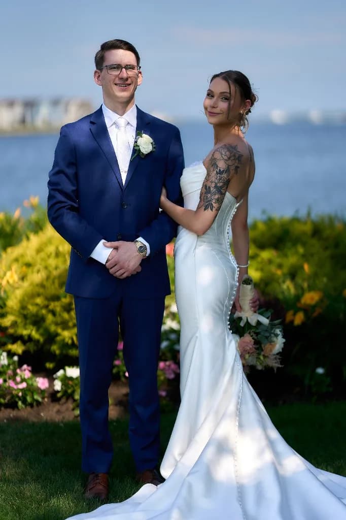 Country Clubs on Long Island, Bride and groom walking hand in hand down the aisle toward the waterfront gazebo at the Riviera